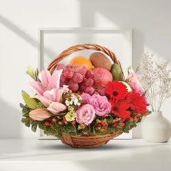 Provocative Basket of Fresh Fruits decorated with Lily, Roses n Gerberas